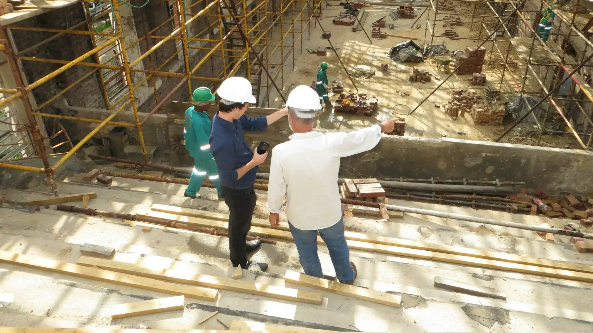Site manager reviewing plans on a construction site