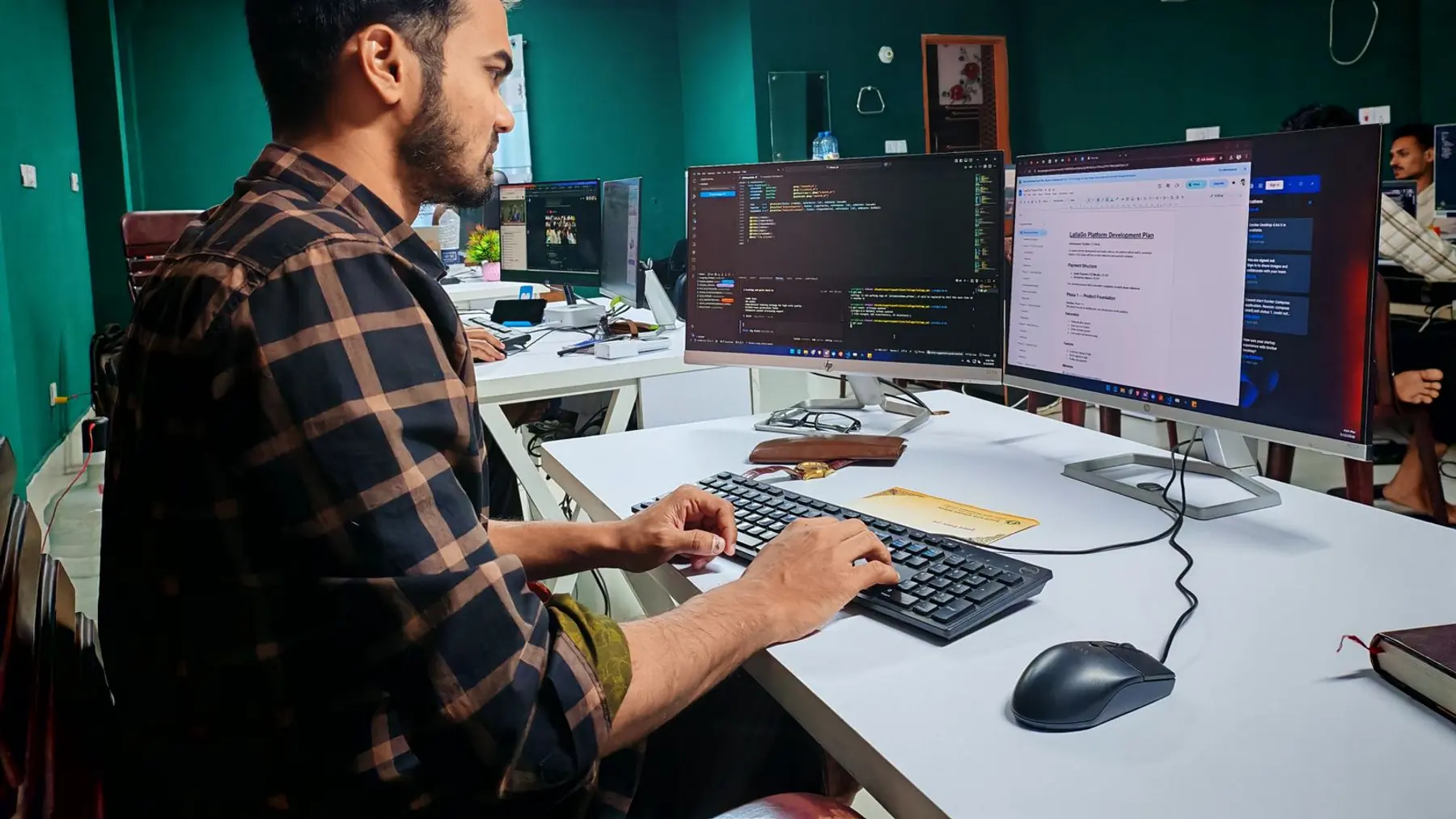 Operations team using a custom software system in a warehouse office